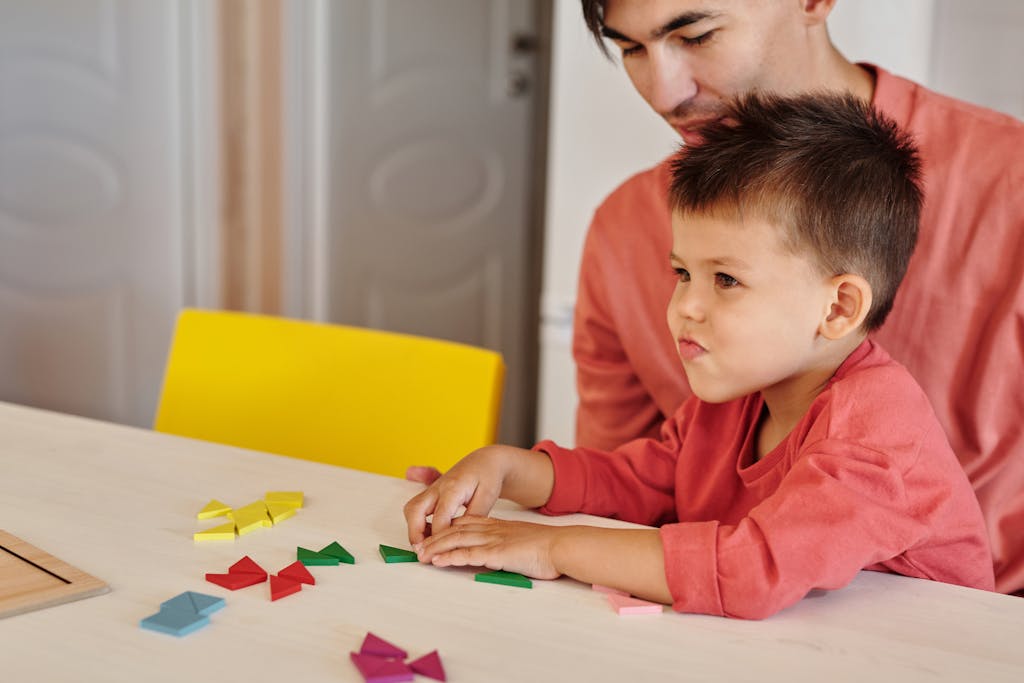 Why Building Relationships in Early Childhood Shapes a Child’s Future 2 A father and son enjoy a bonding activity indoors, playing with colorful tangrams together.